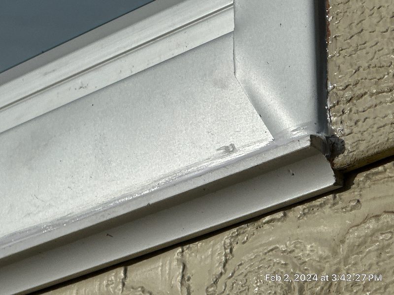 Waterproofing foam being applied around window frame