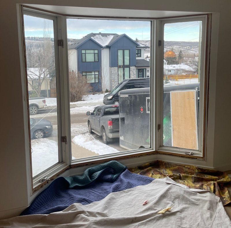 Kitchen protected with plastic sheeting before window installation