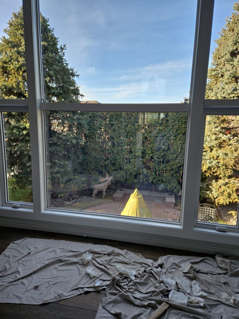 Plywood runners laid across hardwood floors to protect during window installation