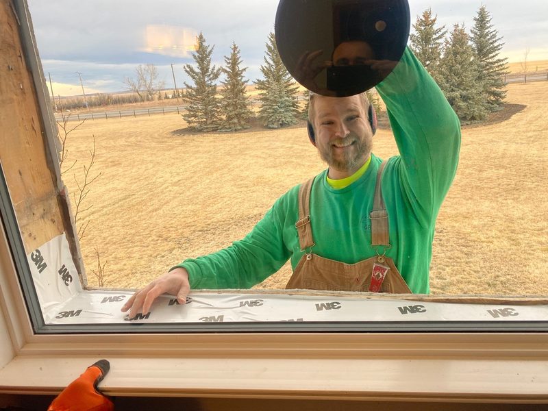 Installer carefully removing old window during tear-out