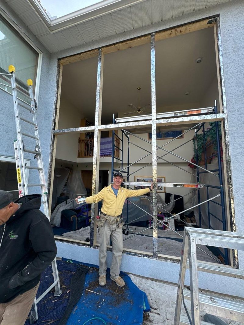 GreenFox team member preparing window frame